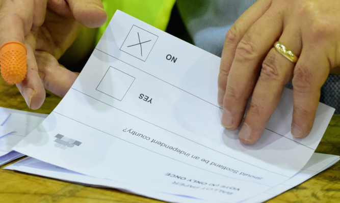 EDINBURGH, SCOTLAND - SEPTEMBER 19:  A cross marks a NO vote on a ballot paper at the count centre for the Scottish referendum at Ingleston Hall on September 19, 2014 in Edinburgh, Scotland. Polls have now closed in the Scottish referendum and the United Kingdom await the results of this historic vote.  With a substantial turnout at the polling stations the vote is too close to call and the result is expected in the early hours of this morning.  (Photo by Jeff J Mitchell/Getty Images) *** BESTPIX ***