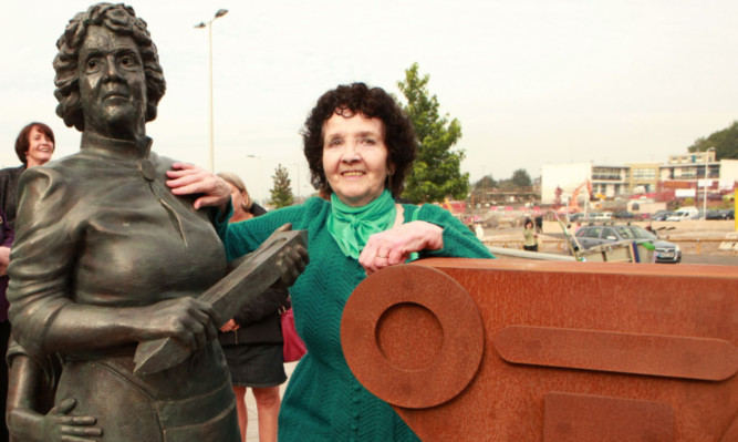 Stella Carrington beside the statue modelled on her.