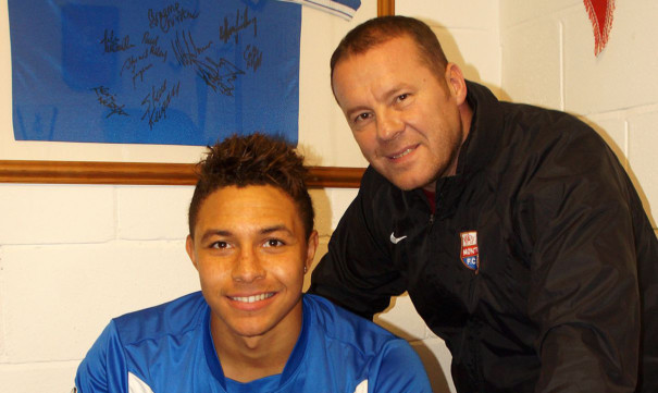 Leighton McIntosh signing his short-term deal with the Gable Endies, watched by George Shields.