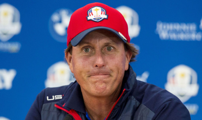 Phil Mickelson talks to the press.