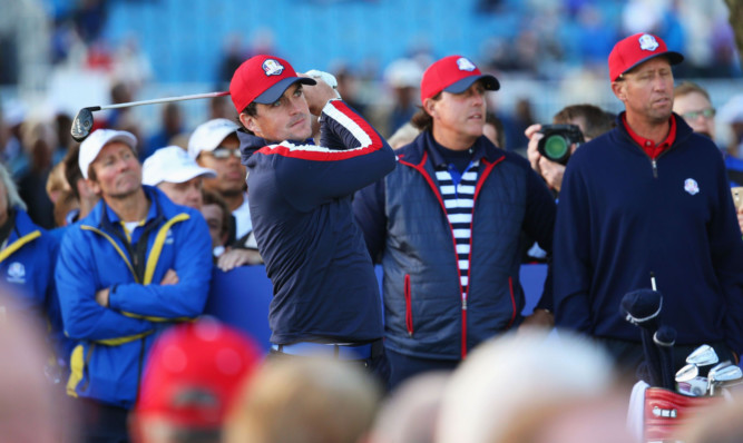 Phil Mickelson watches partner Keegan Bradleys tee shot at the 11th hole.