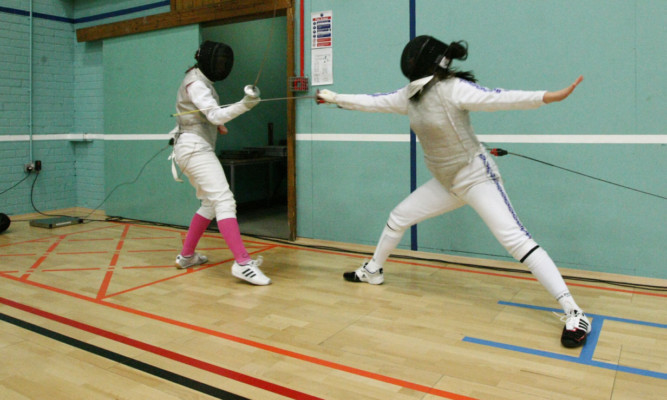 Pupils giving a fencing demonstration on the new floor.