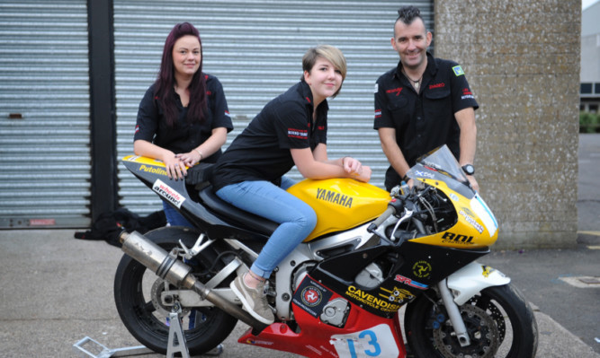 Hedz Up founder Ian Pert with Zoe Wilkie and Bobbi Murray, who have worked on a race bike for the Isle of Man event.