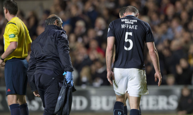 James McPake receives treatment during the midweek derby clash.