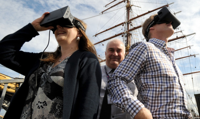 Gill Porter and Mark Munsie of Dundee Heritage Trust and Ben Bennett from Digital Surveys with one of the virtual reality headsets