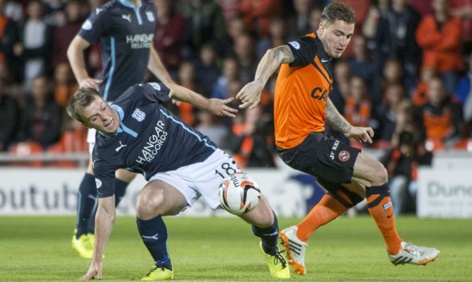 Paul McGowan gets stuck in against Paul Paton on Wednesday.