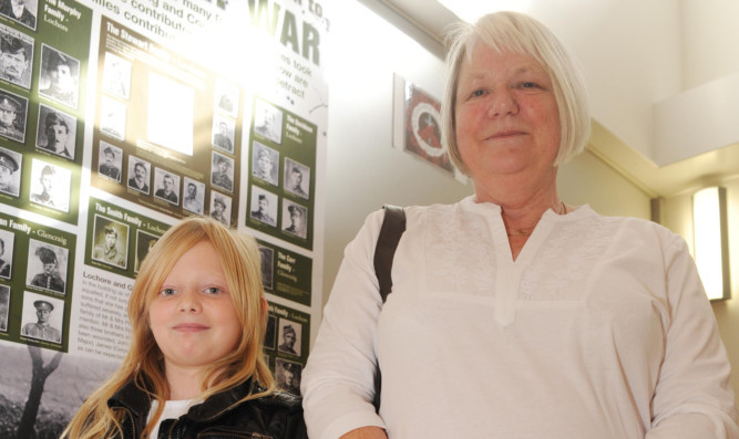 Kiera and Margaret in front of a display of their family's war experience.