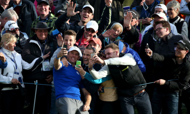 Europe's Lee Westwood takes a selfie with adoring fans.