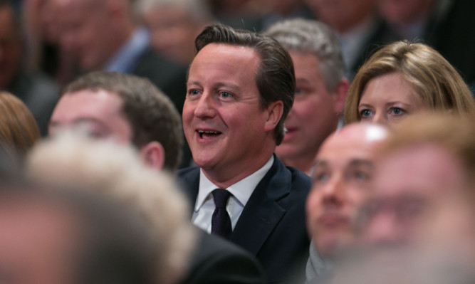 David Cameron listens to George Osborne address the party conference.