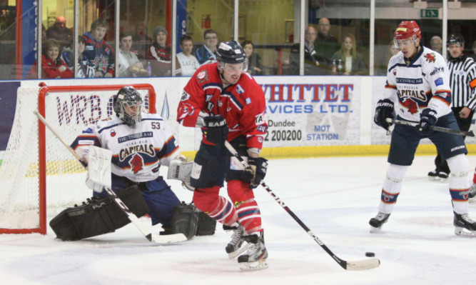 Dundee Stars player-coach Jeff Hutchins attempts to tip the puck past Capitals goalie Tomas Hiadlovsky in Sundays clash at the Dundee Ice Arena.