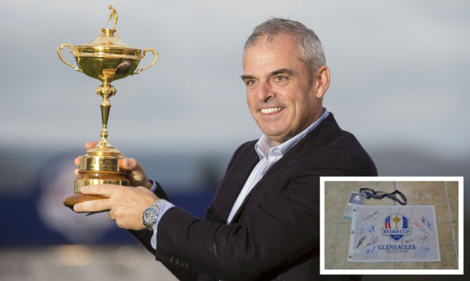 European captain Paul McGinley signed the flag (inset) along with the rest of the victorious Ryder Cup team.