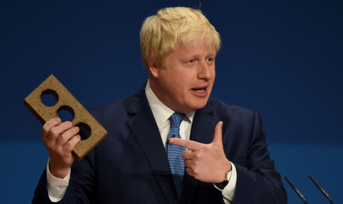 Boris Johnson wielded a brick to promote housebuilding during his joke-filled speech.