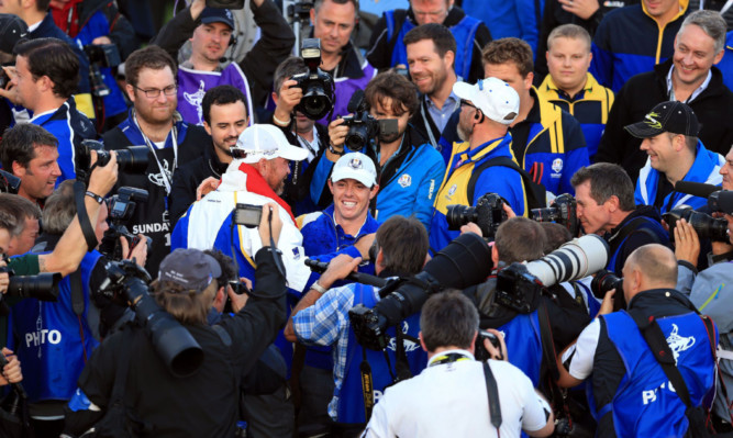 Rory McIlroy is mobbed by the media after the victory at Gleneagles.
