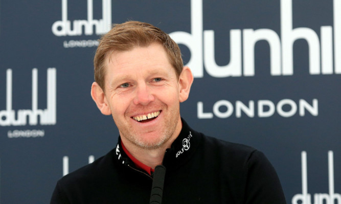 Stephen Gallacher in good spirits as he addresses the media.