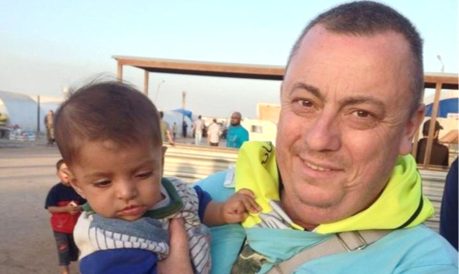 An IS video claims to show the beheading of British man Alan Henning.