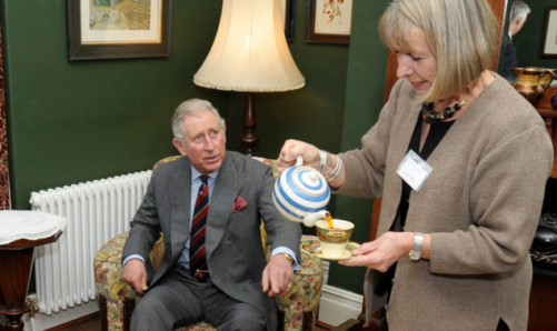 The Prince of Wales is served tea in the birthplace of Dylan Thomas in Swansea by restorer of the house Anne Haden.