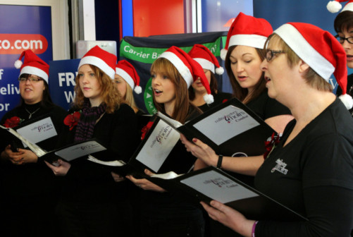 The choir singing for shoppers.