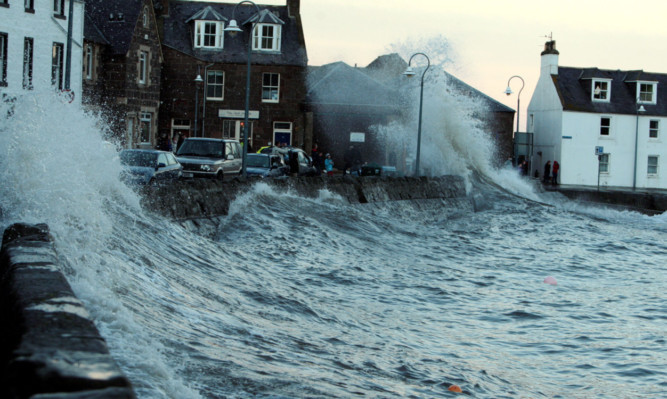 Waves crash over the inner harbour walls at Stonehaven on Saturday.