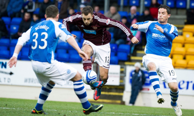 Gordon Smith is kept in check by St Johnstone's Thomas Scobbie and Gary Miller.