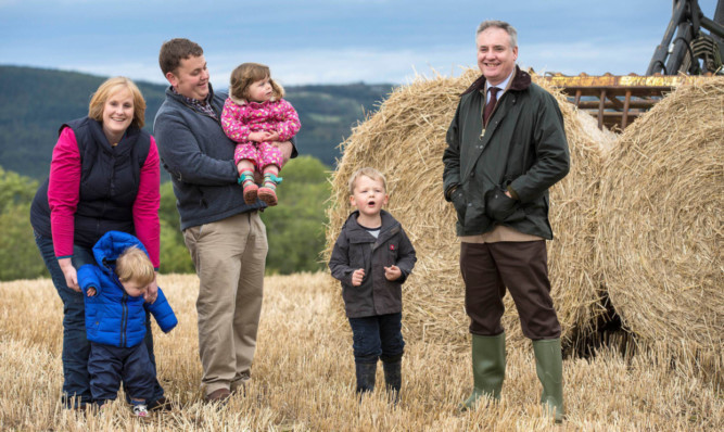 Rural Affairs Secretary Richard Lochhead visiting the first Government starter farm, Balrobert, near Inverness, to meet new tenants Douglas and Grace-Ann Bennie with children Alexander, 4, Molly, 2, and John, 1.