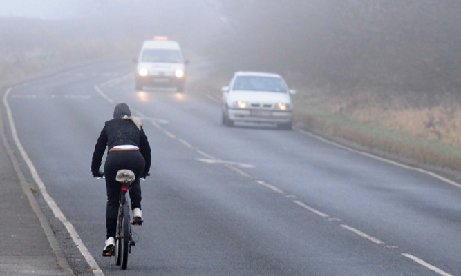 Cyclist in foggy conditions, South Derbyshire.                    . PRESS ASSOCIATION Photo. Picture date: Wednesday December 12, 2012. See PA story. Photo credit should read: Rui Vieira/PA Wire