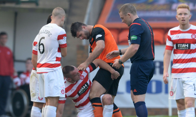 Referee John Beaton waits to book both players after Nadir Ciftci clashed with Hamiltons Darian MacKinnon during last months game at Tannadice.