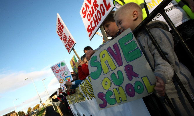 Parents and children campaign outside the school.