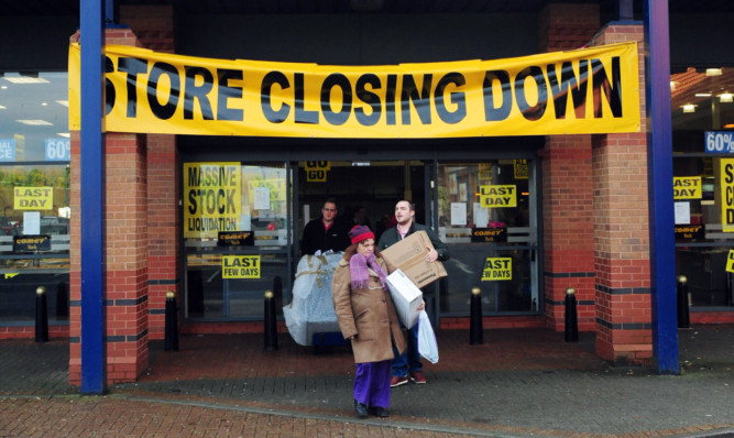 People leave a Comet store in York on its final day of trading.