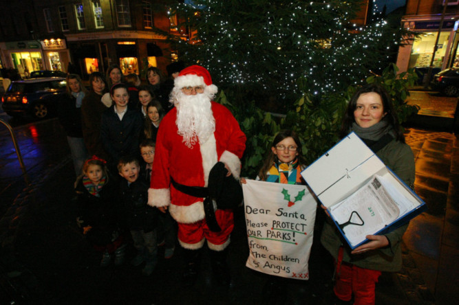 Arlene Law (right, with the petition) and other protestors in Forfar before delivering the 'present' to Angus Council.