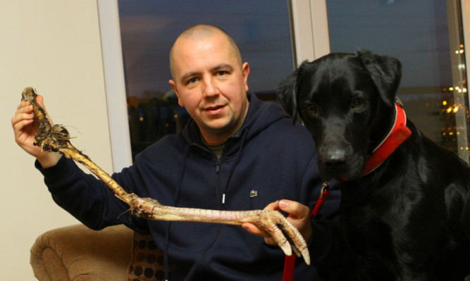 Sean Donaldson with the claw that his dog Oscar found.