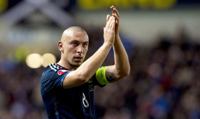 Scotland captain Scott Brown applauds the fans at full-time against Georgia.
