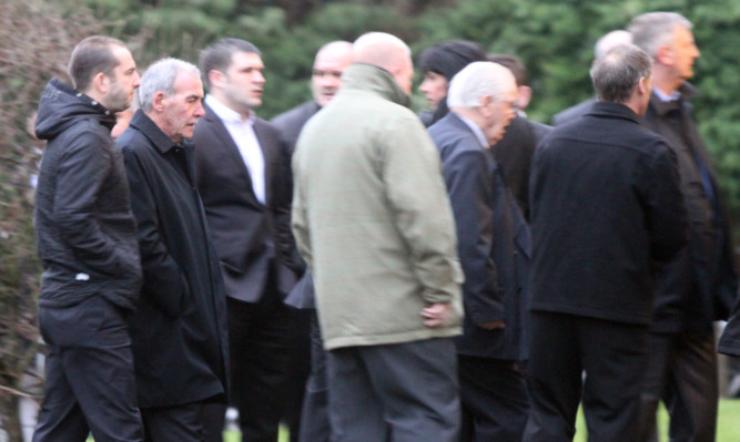 Mourners, including Jocky Scott, at the funeral.