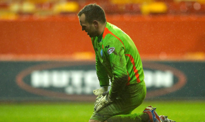 St Johnstone keeper Alan Mannus is a picture of dejection after losing 2-0.