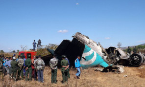 Emergency workers stand by the wreckage of the Air Bagan plane.