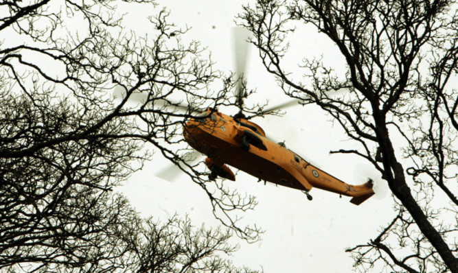 A helicopter from RAF Kinloss scours Moncreiffe Hill after reports a walker may have fallen.