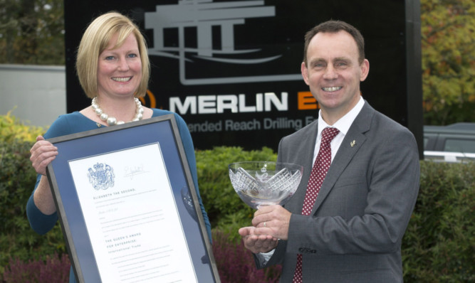 Debbie and Iain Hutchison of Merlin ERD with their Queens Award certificate and crystal bowl.