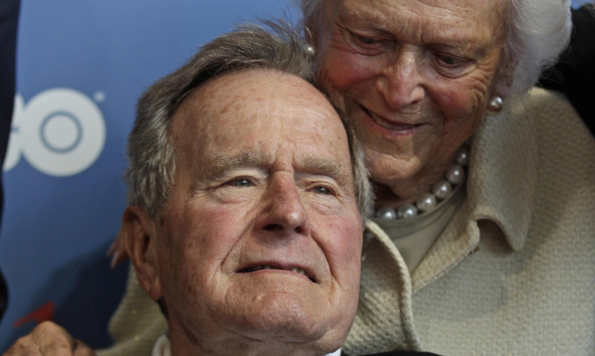 Former US president George HW Bush pictured in June with his wife Barbara.