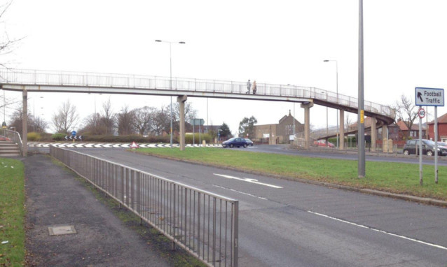 The pensioner was robbed on the footbridge across the Kingsway.