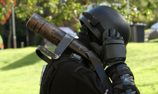 A Tayside drugs squad officer preparing to raid a property.