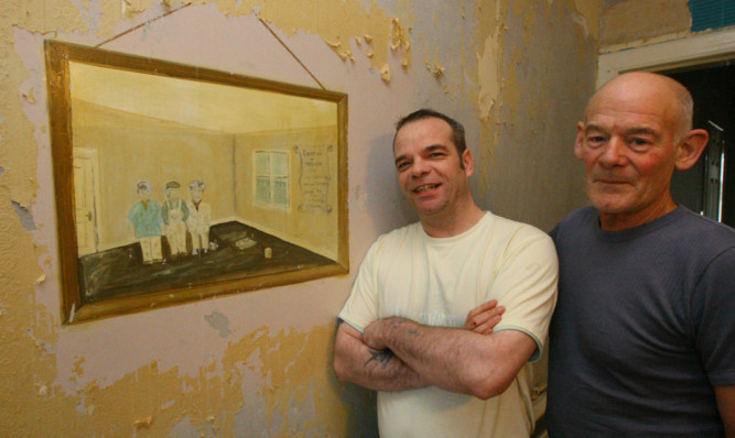 Scott Oswald (left) and neighbour Alan Rodger with the portrait they have unearthed.