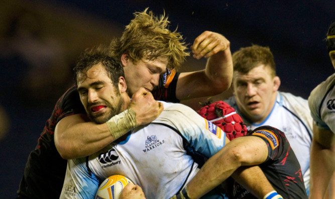 Glasgow Warriors Josh Strauss is stopped in his tracks by David Denton and Sean Cox.