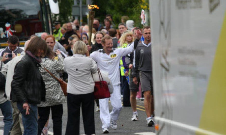 Ronnie enjoys his moment with the Olympic Torch.