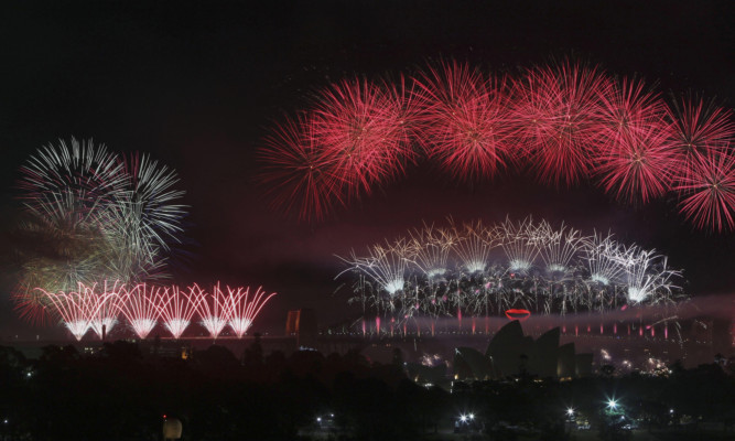 Fireworks explode in the sky above Sydney Harbour as it is among the first cities in the world to welcome 2013.