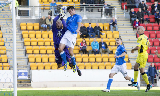 Brian Graham challenges St Mirren goalkeeper Marian Kello in the air.