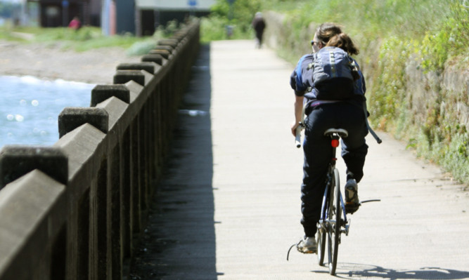 A cyclist enjoying a sunny route into Dundee.