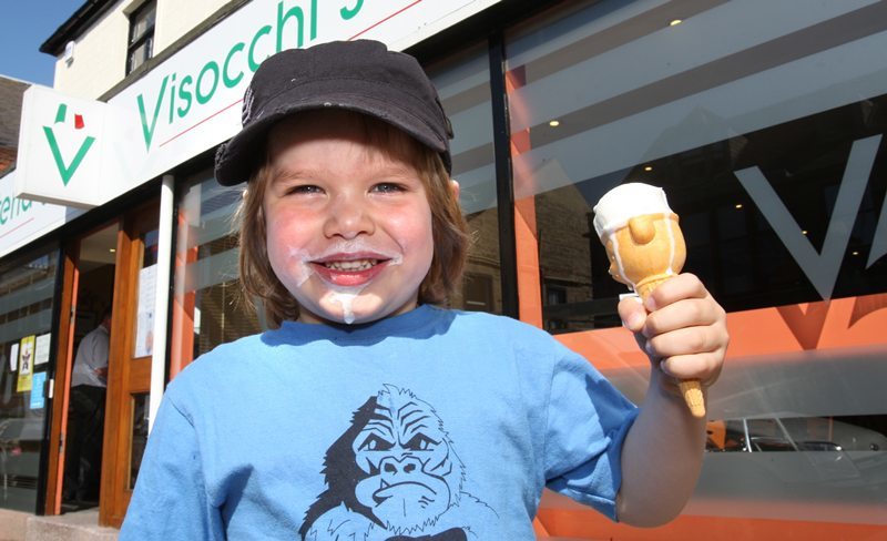 Kris Miller, Courier, 18/05/10, News (Weather). Pic today at Visocchi's Ice cream shop, Broughty Ferry. The store ran out of ice cream today just before closing time due to the increased business thanks to the heat wave. A busy day lies ahead in preperation to restock for the rest of the week. Pic shows Harvey Gay enjoying his ice cream outside the shop.