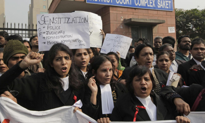 Indian women lawyers shout slogans outside the court complex in New Delhi.
