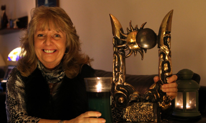 June at home with the International Battle of the Psychics trophy she won in Ukraine.