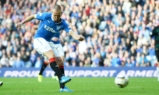 Rangers striker Kenny Miller scores his sides third goal of the game.