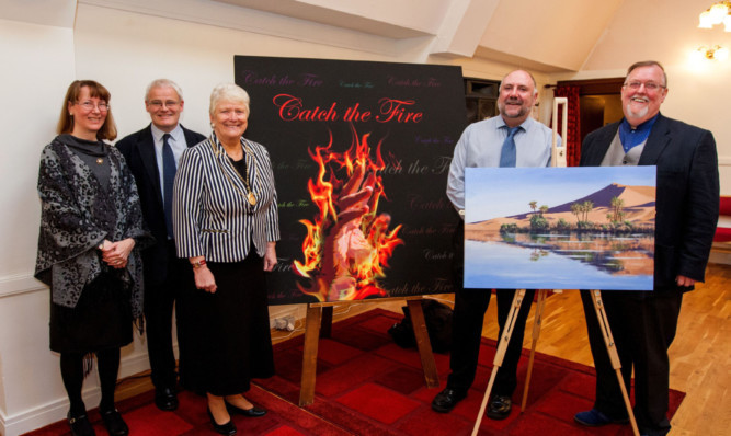 From left: pastors Kim Duncan and husband Robert Duncan, Provost Liz Grant and artists John Halvorsen and Dave Smith with the two paintings at the Oasis Church Perth.